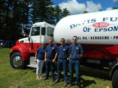Three Davis Fuels staff members standing beside a branded delivery truck